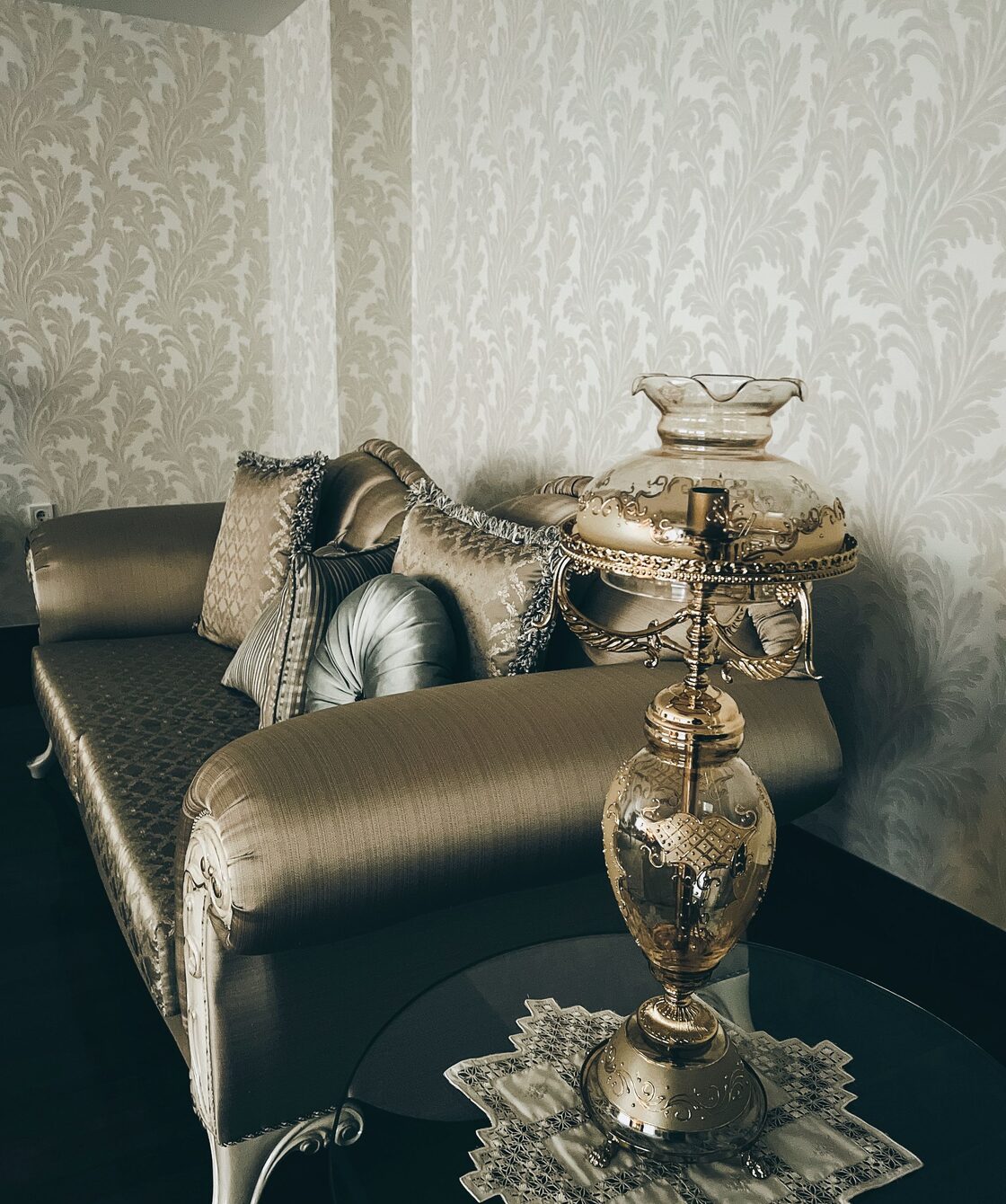 Refined sitting room with champagne-toned damask wallpaper and a classic chaise lounge